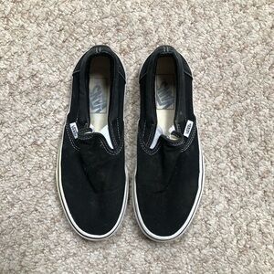 Unisex black/white Vans. Size 7 (women), 5.5 (men)